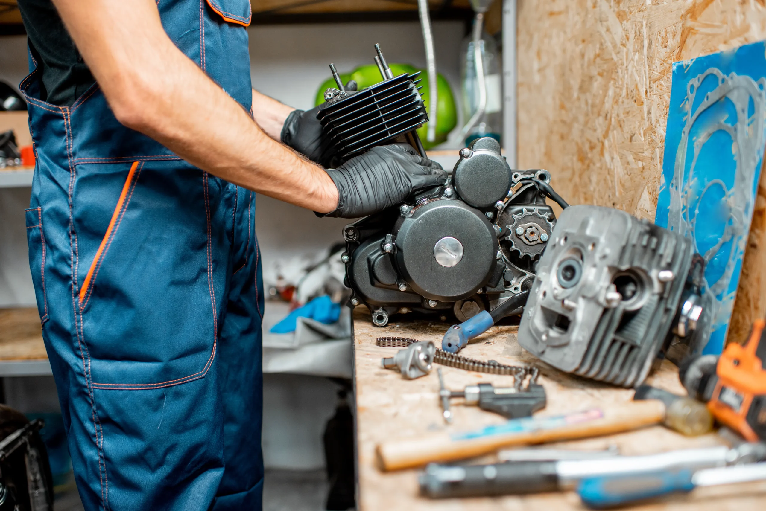 a man checking an engine on a table for future use.